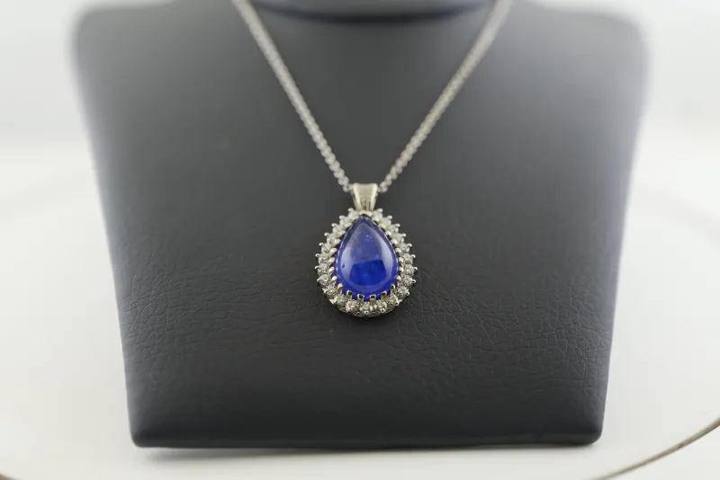 Raw product photograph of a blue pendant necklace